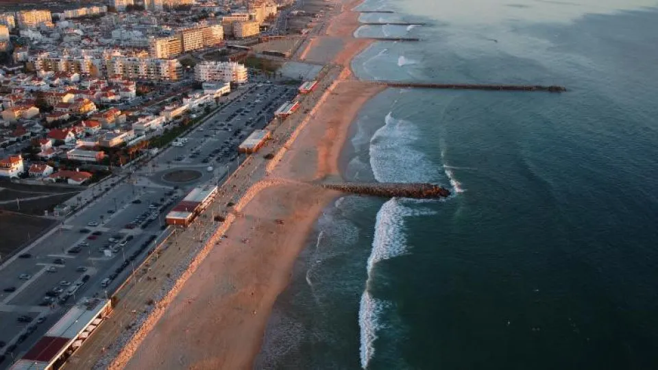 Vista aérea da frente marítima de Setúbal, com a praia, o mar e a zona urbana da cidade